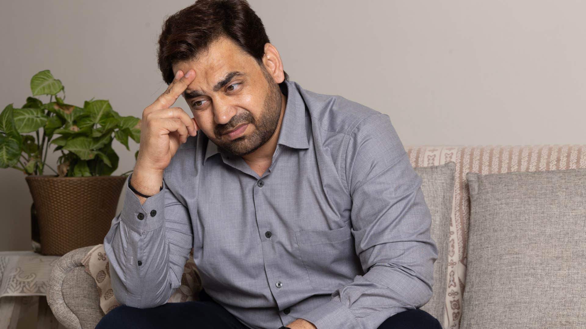 sad man who suppresses his complex emotions