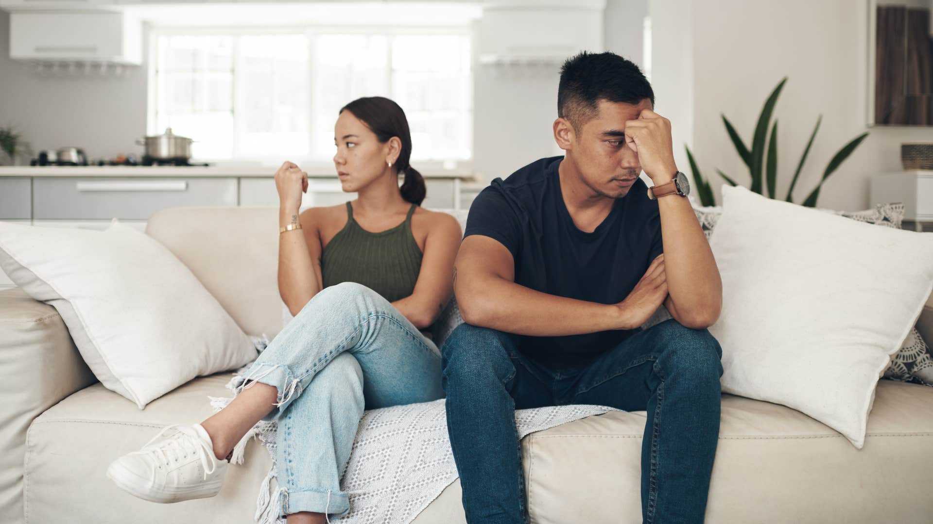 bored couple dreading quality time together on the couch
