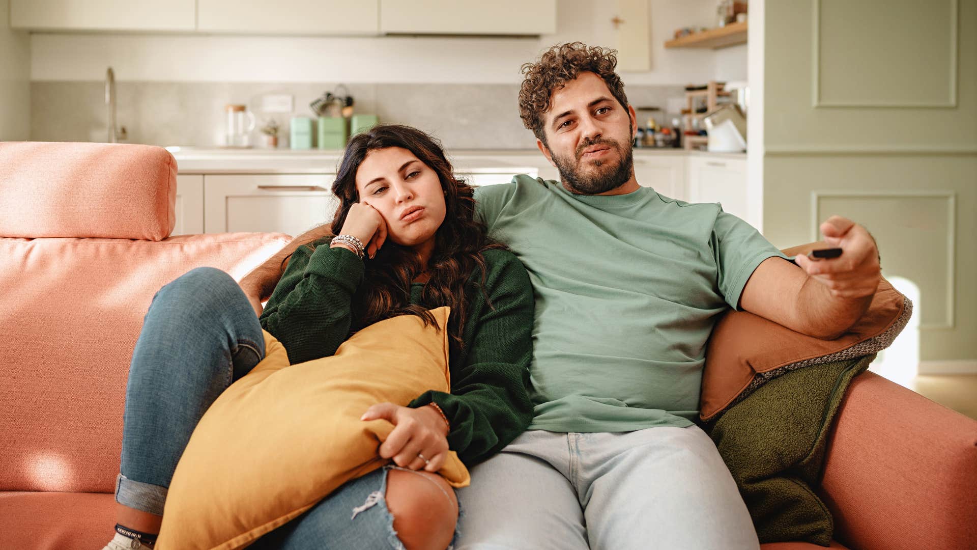 bored couple watching television feeling like roommates instead of partners
