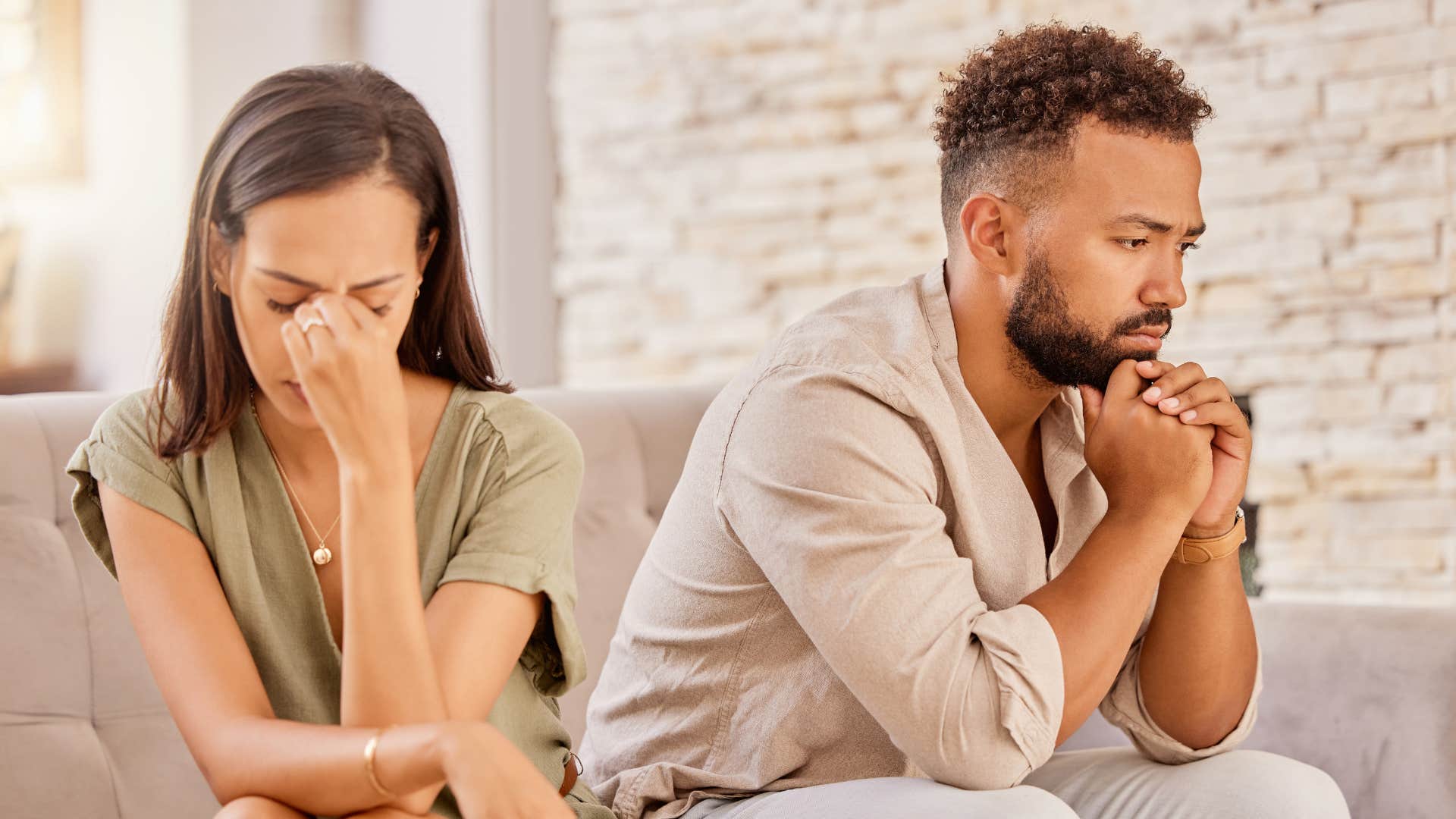 Serious couple think deeply showing way to explain breakup