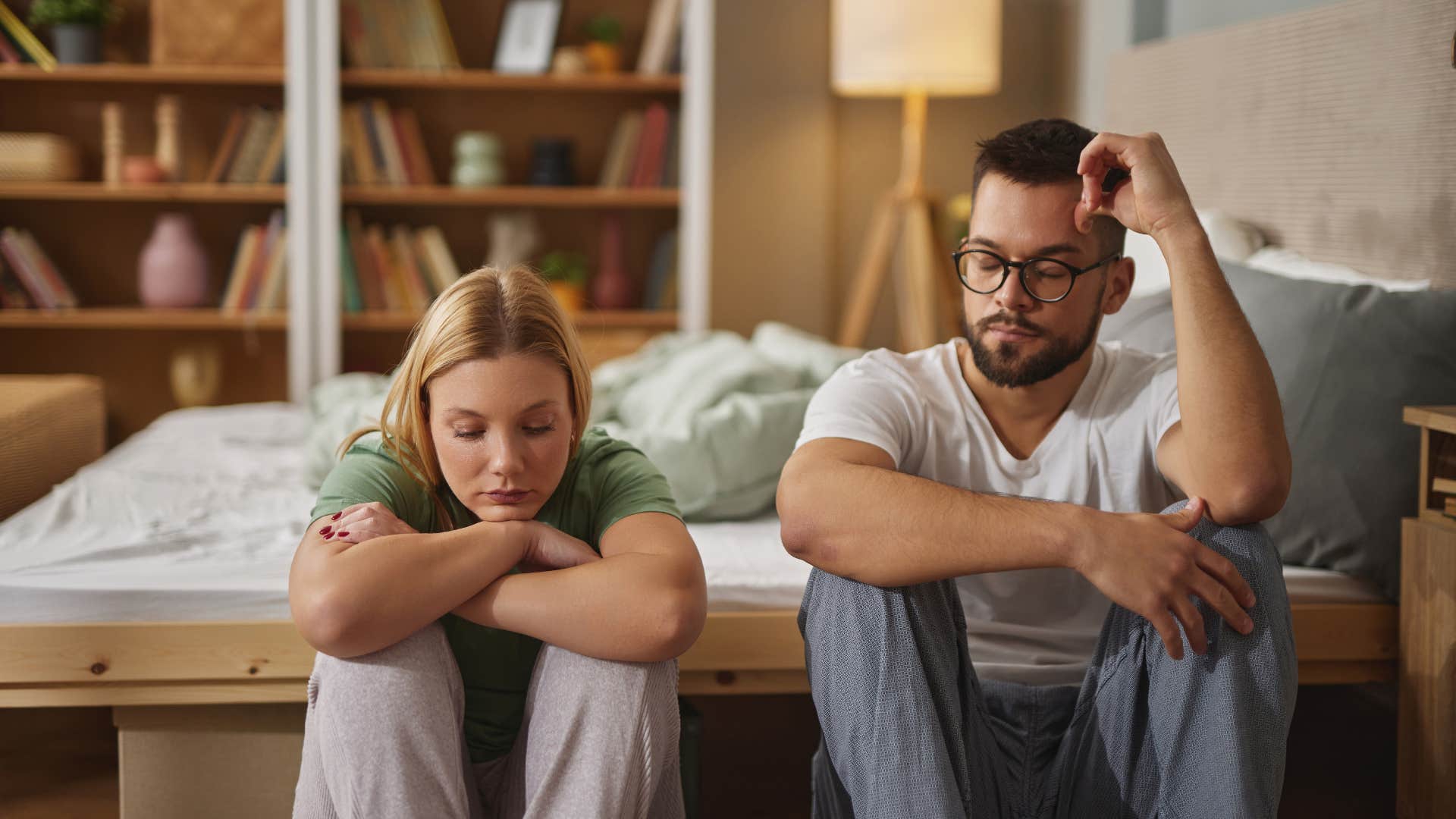 Sad couple sit on floor showing honest breakup