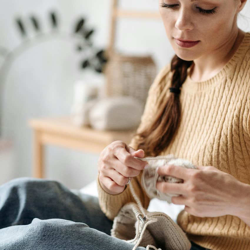 woman knitting with yarn