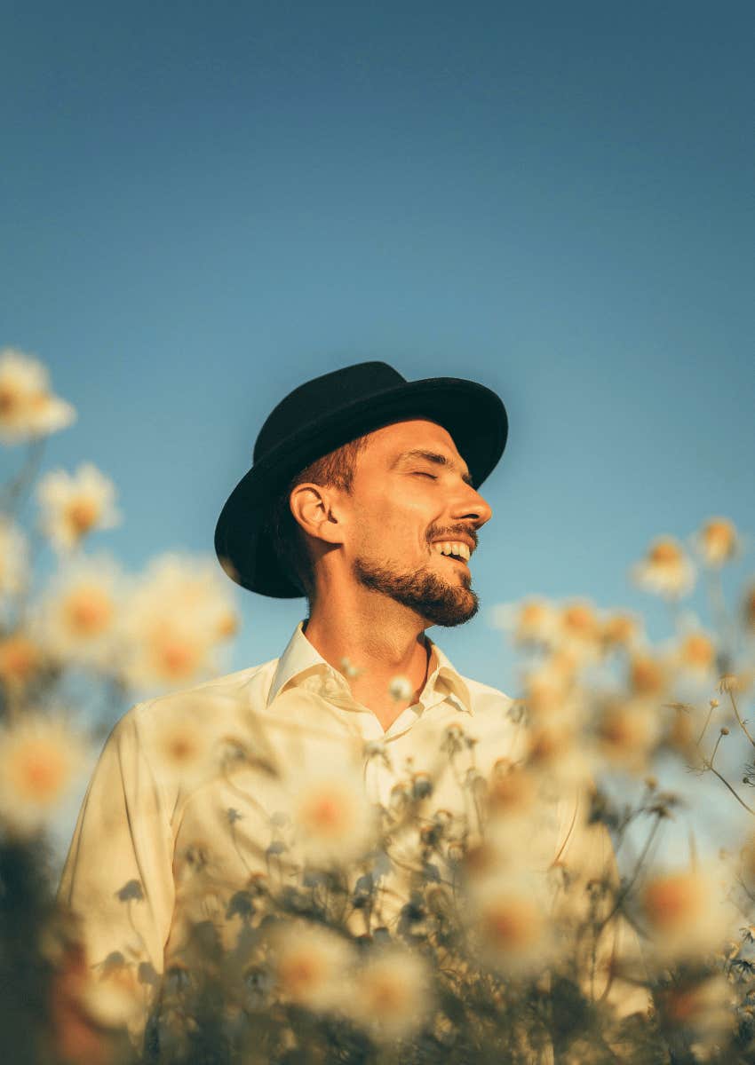 optimistic young man standing outside