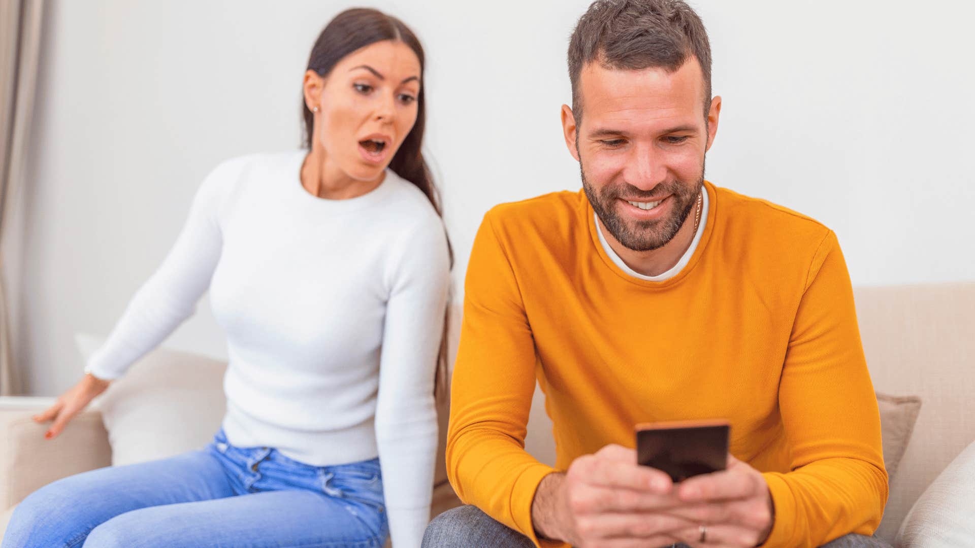 woman looking over man's shoulder at home becoming partner they never wanted to be