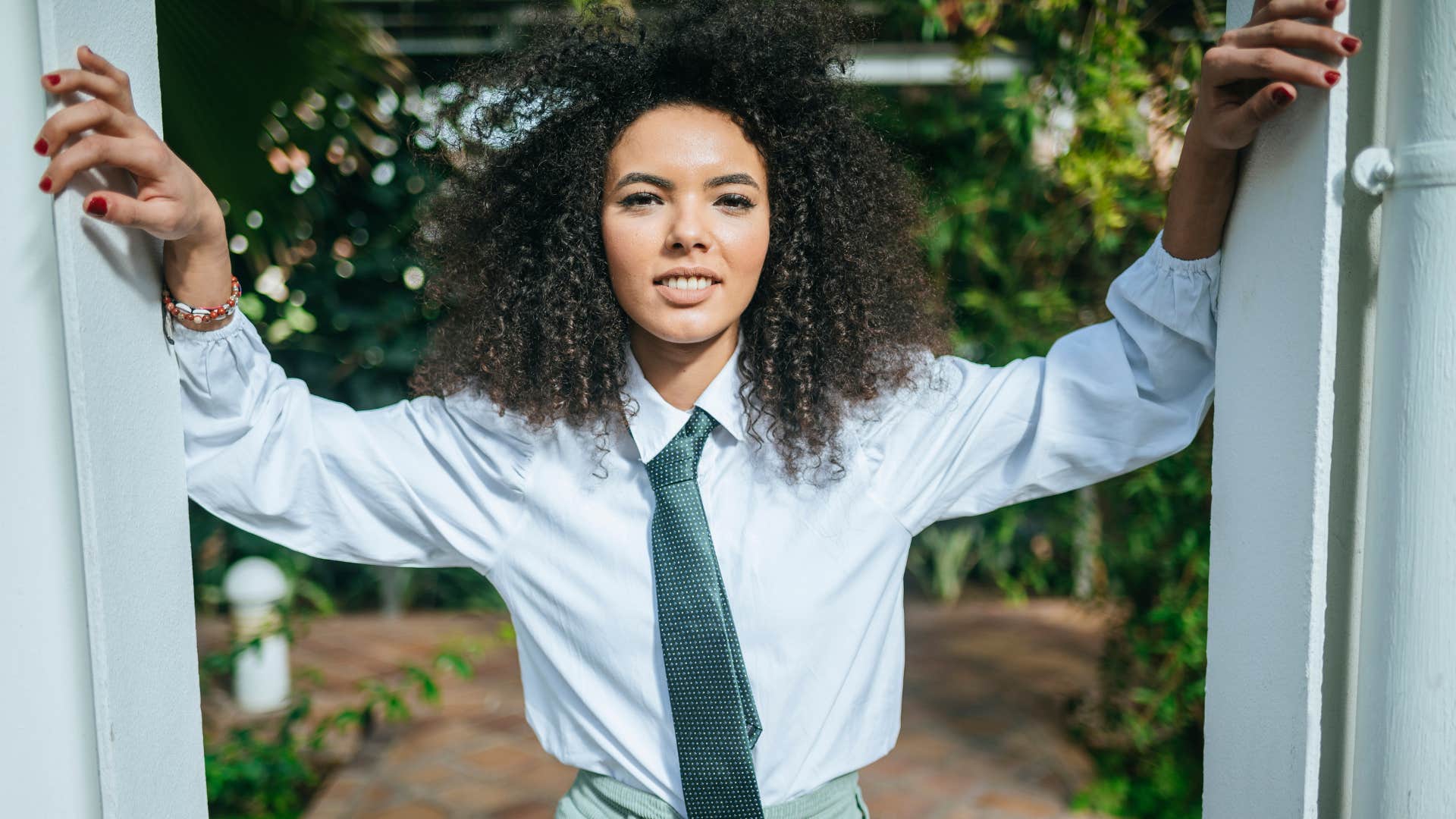 Confident person leans in doorway showing responsibility