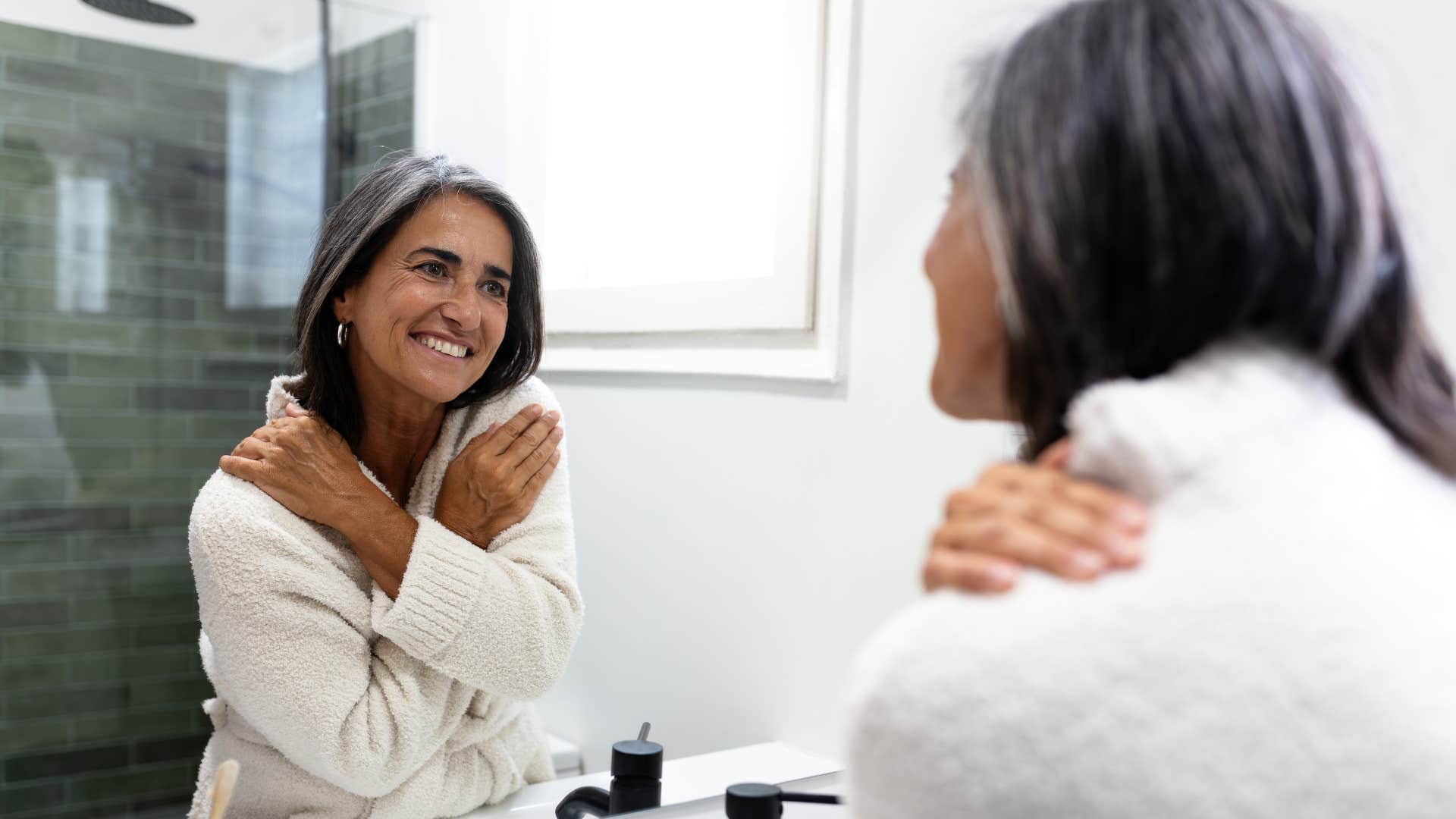 Distinctively happy person gently hugs self