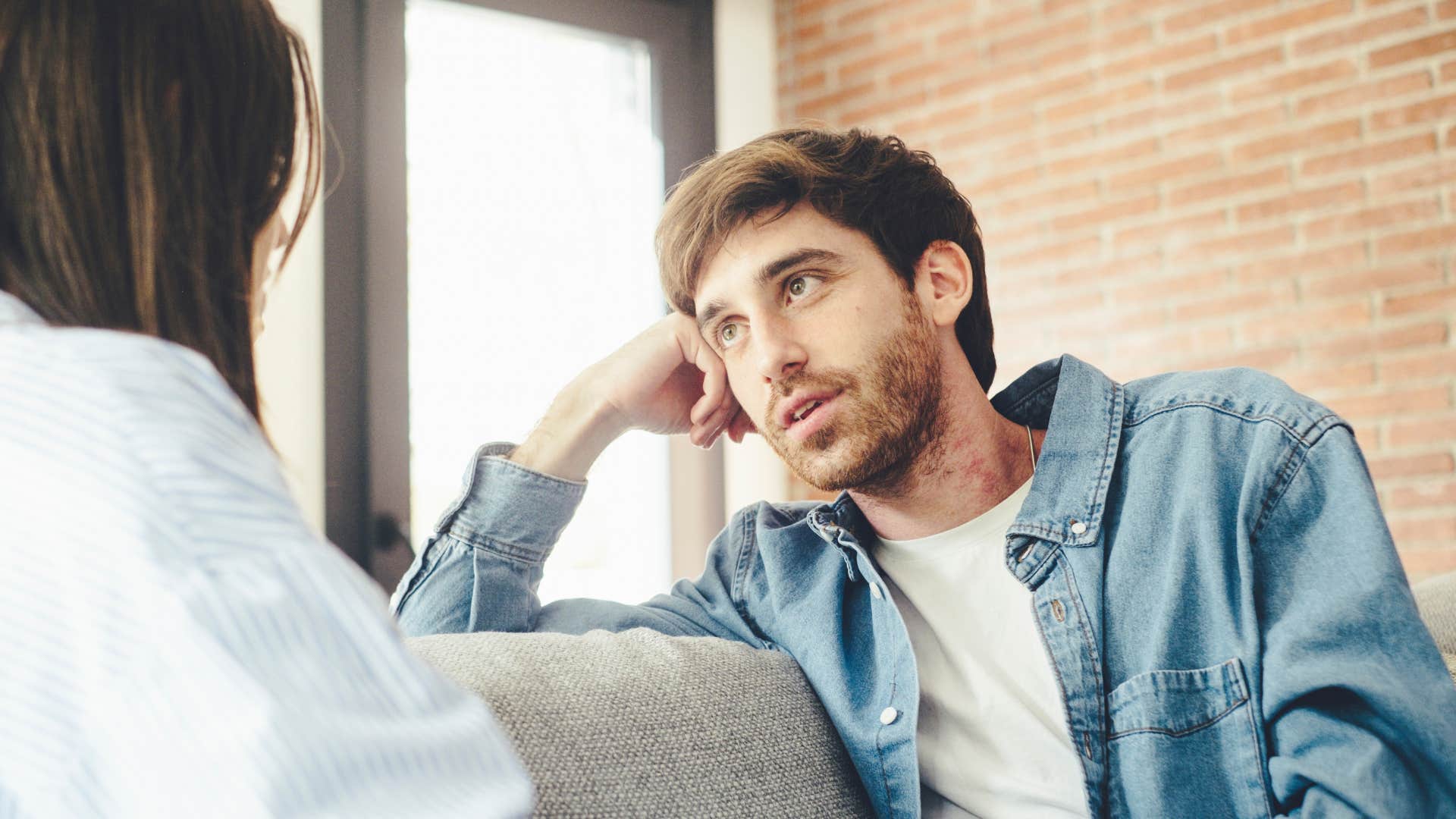 man pretending to pay attention telling partner that happened to me
