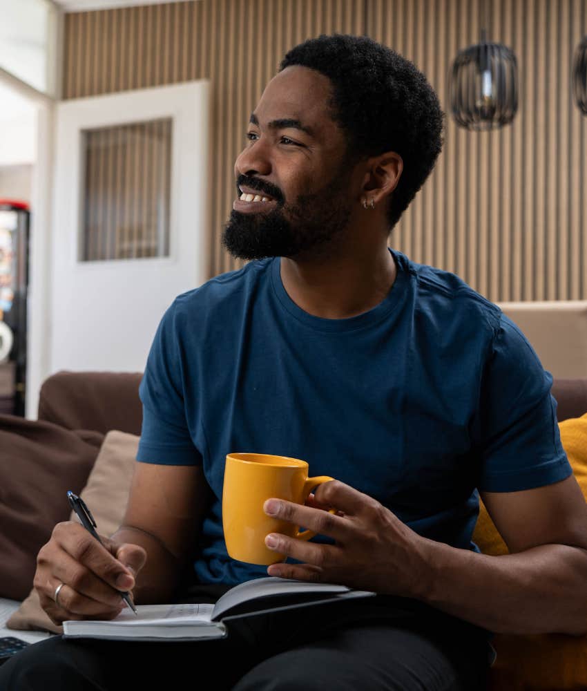 Happy person writes in journal showing way to be present despite chaos