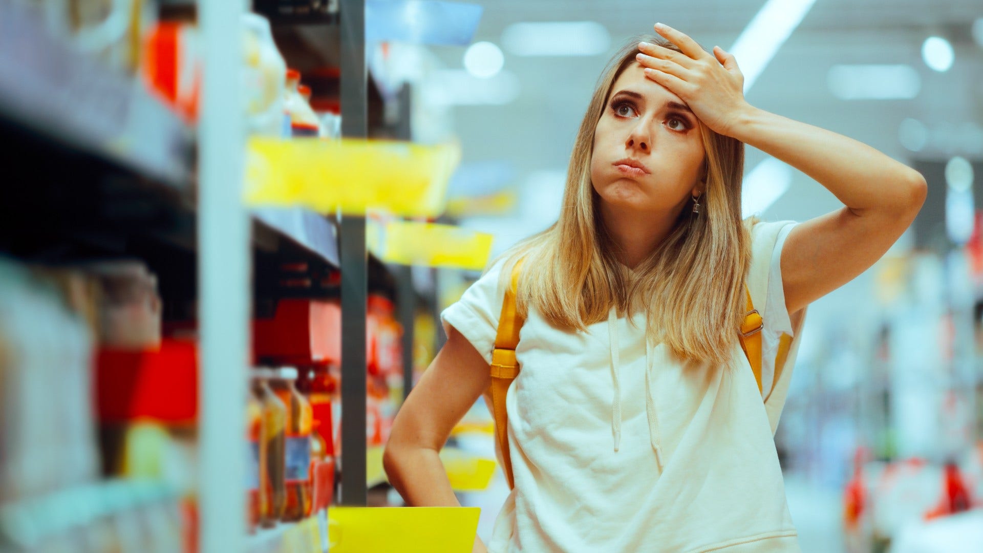 woman who grew up in a financially unstable home overanalyzing grocery prices