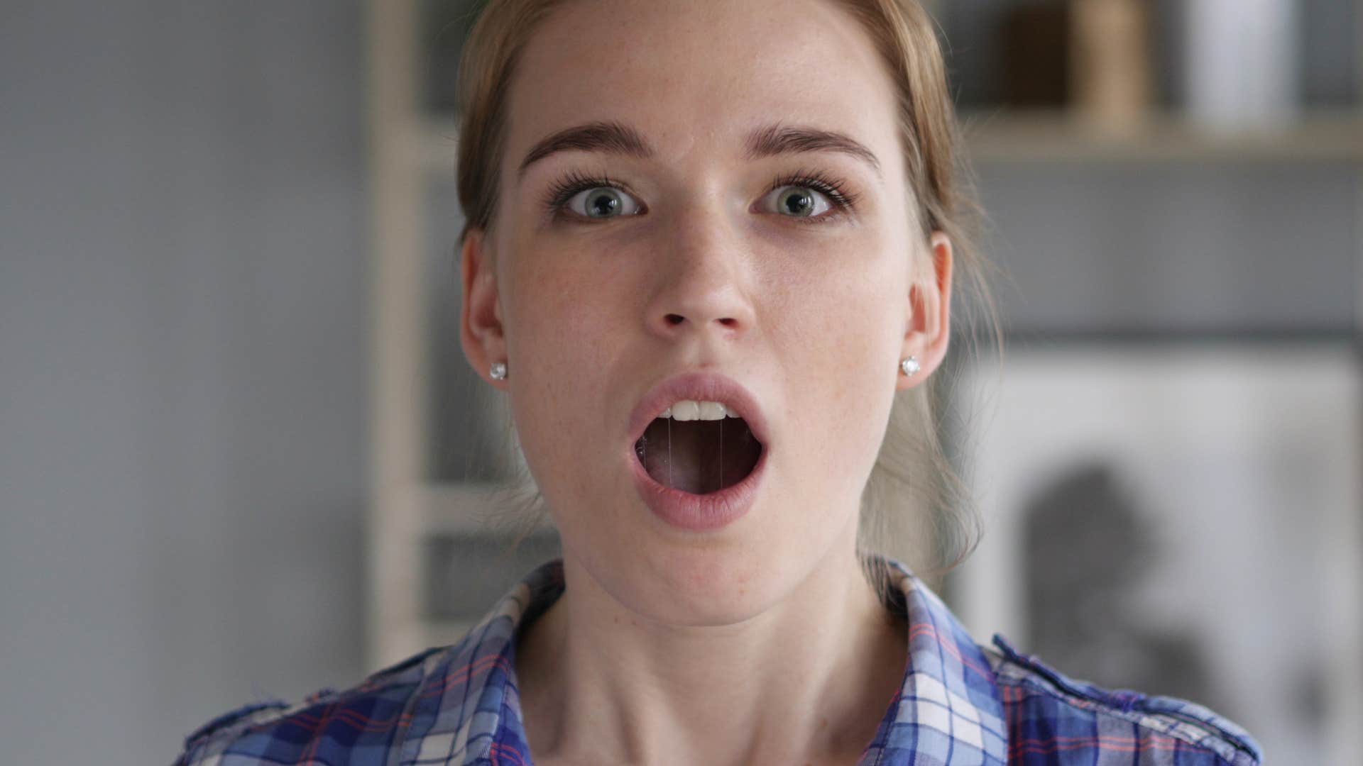 woman who hates opening gifts in front of others looking surprised