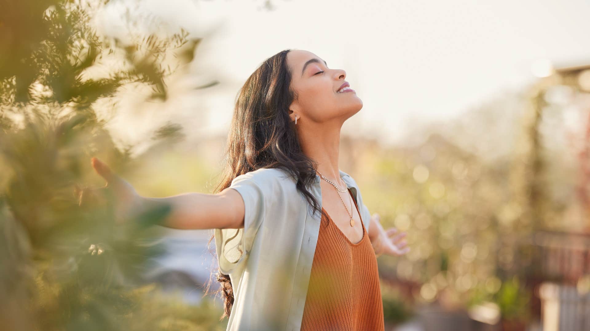 intuitive woman deep breathing outside