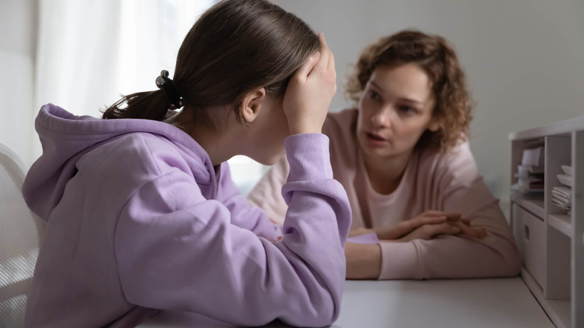 Woman curating extracurriculars for a college application with her daughter.