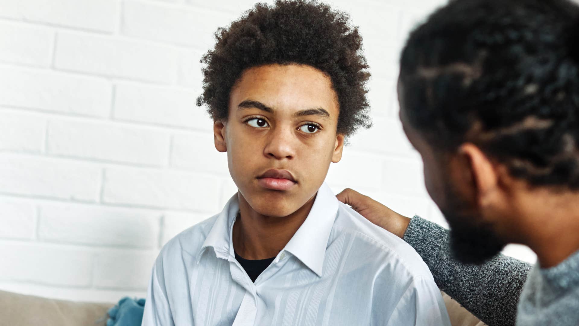 Boy talking about feelings and mental health with his dad.