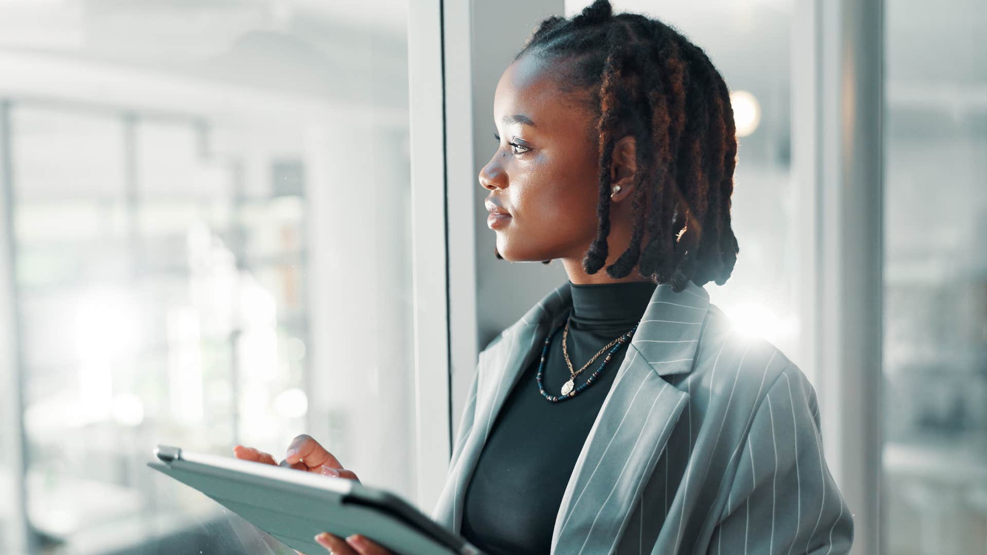 woman being conscientious as she stares out window thoughtfully