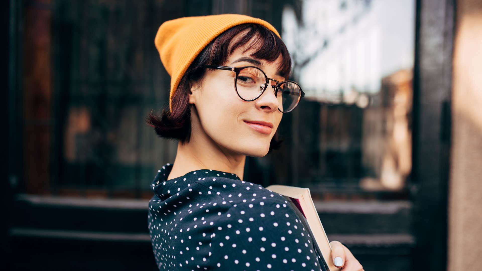 Smug person with book showing struggle with perfectionism