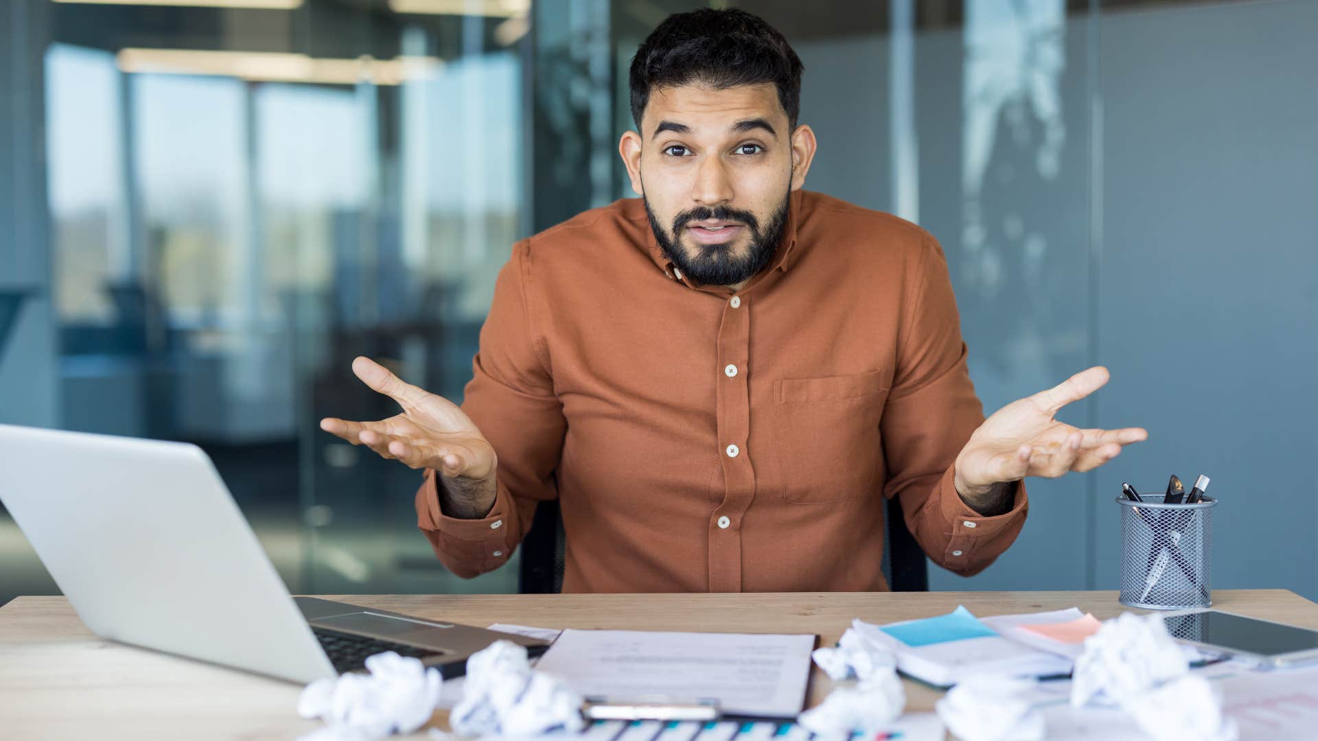 Confused office worker with messy showing showing struggle to please others