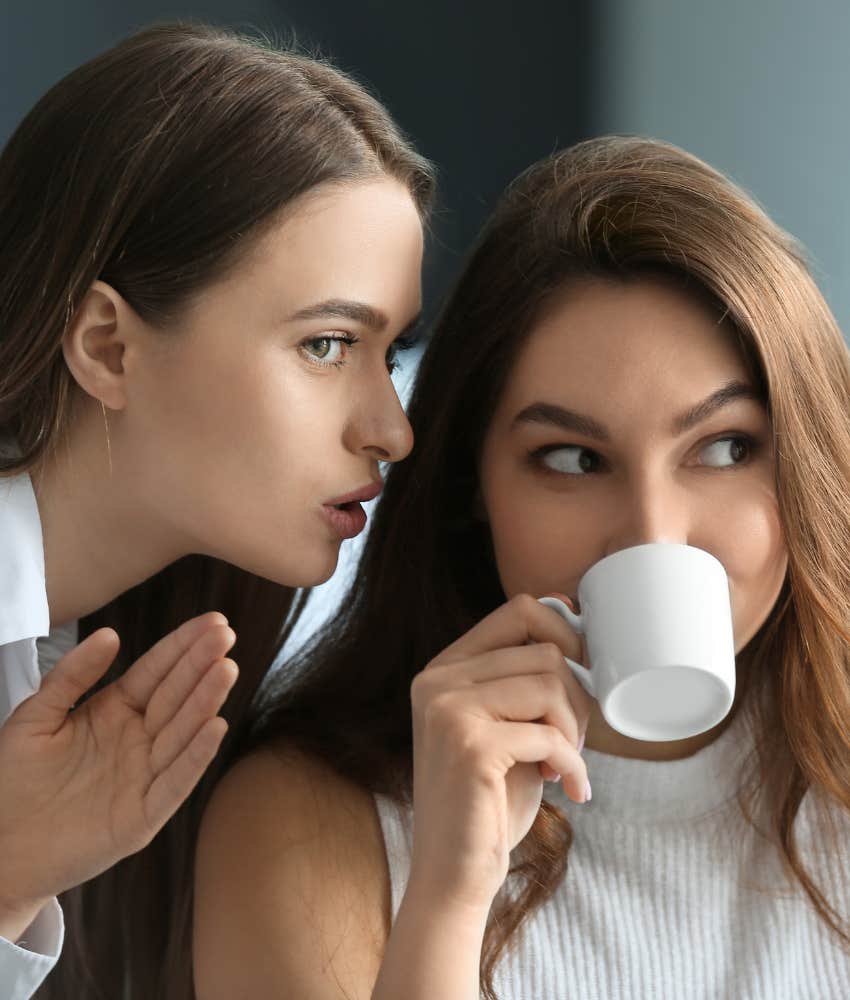self-critical person whispers gossip in friend's ear showing insecurity