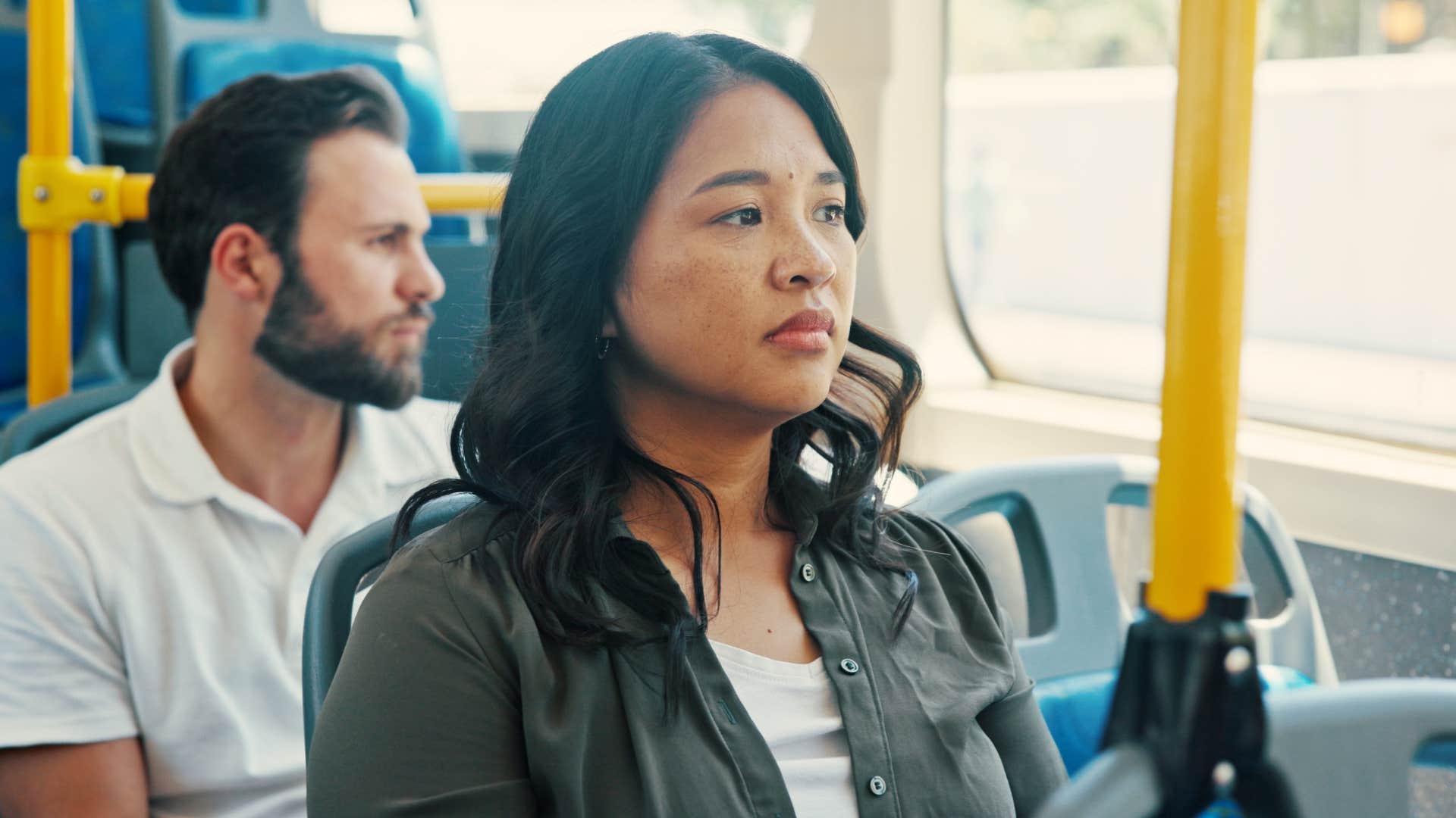 woman in bus having highly sensory awareness as she stares out window