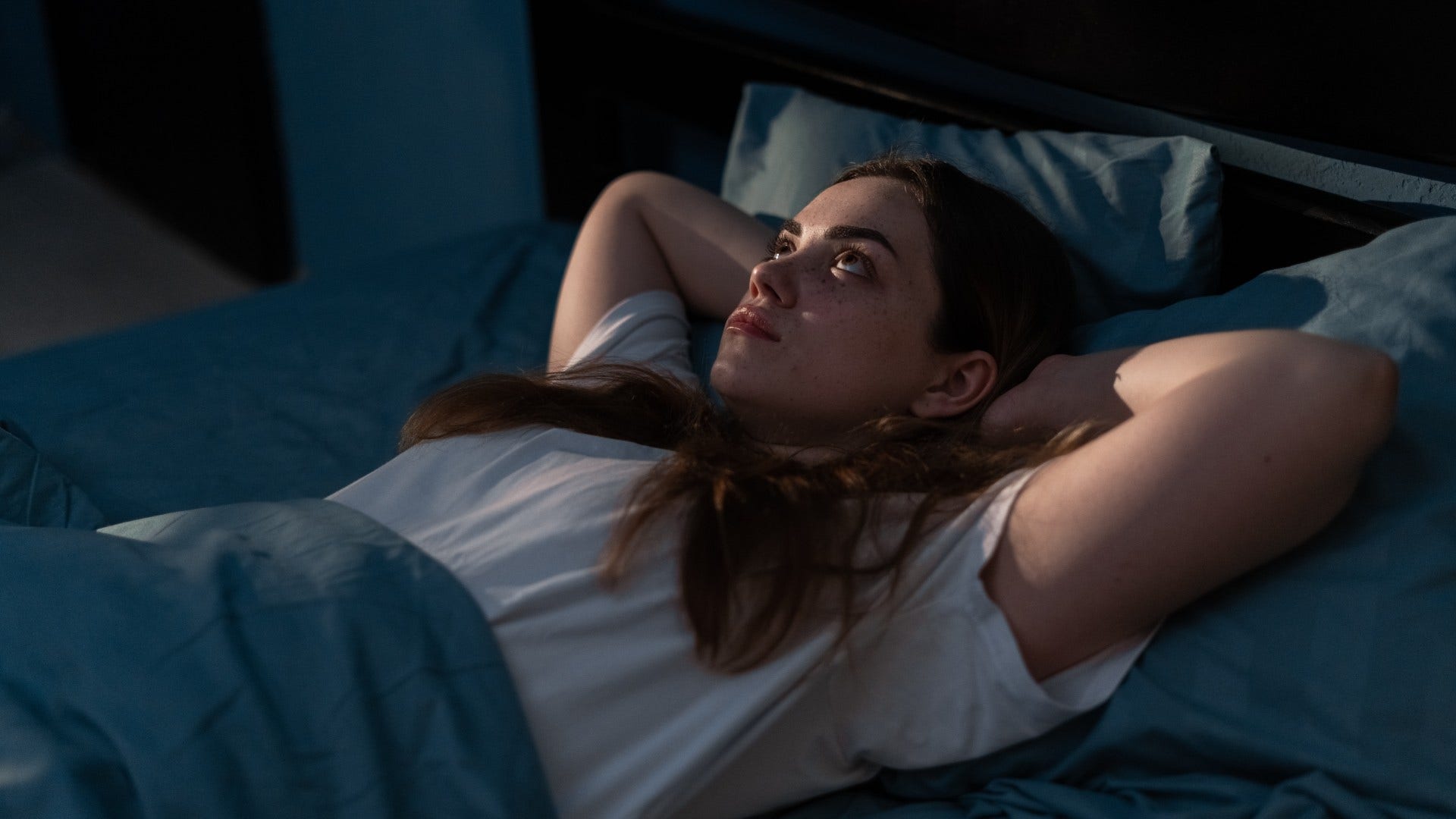 woman who struggles to turn her brain off at night as she equates stillness with productivity