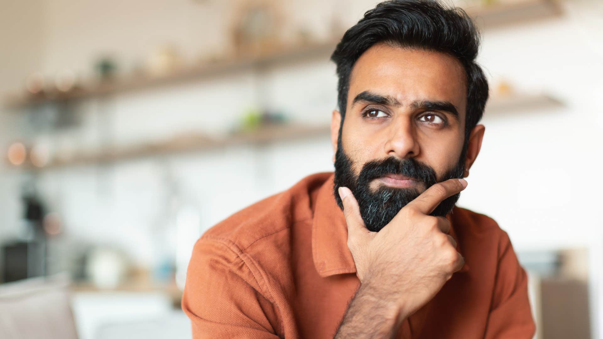 man who wears the same type of outfit every day deep in thought