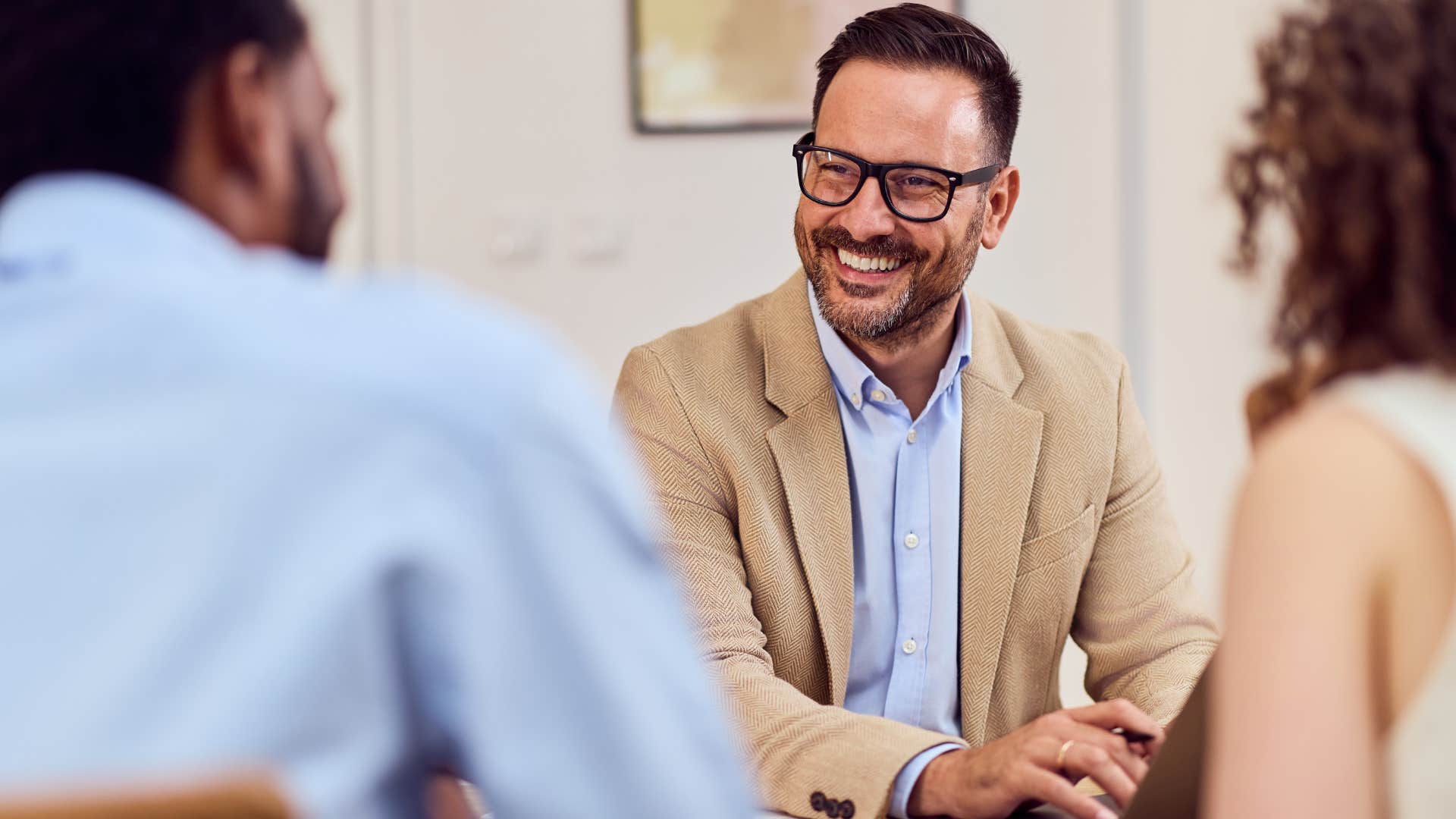 man who cares about showing up emotionally smiling with friends