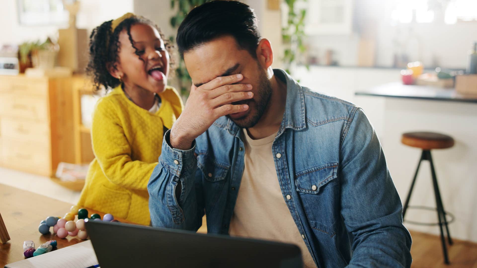Man who's easily overstimulated sitting with his daughter.