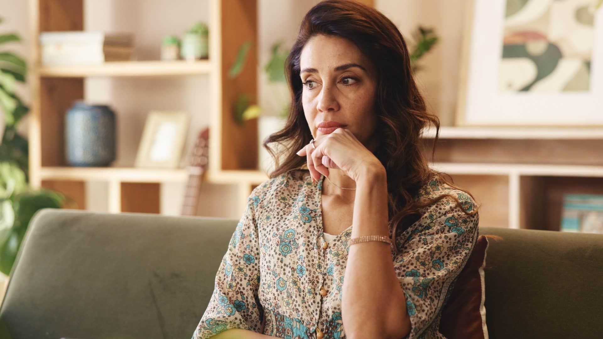 woman who's emotionally self-aware thinking alone at home