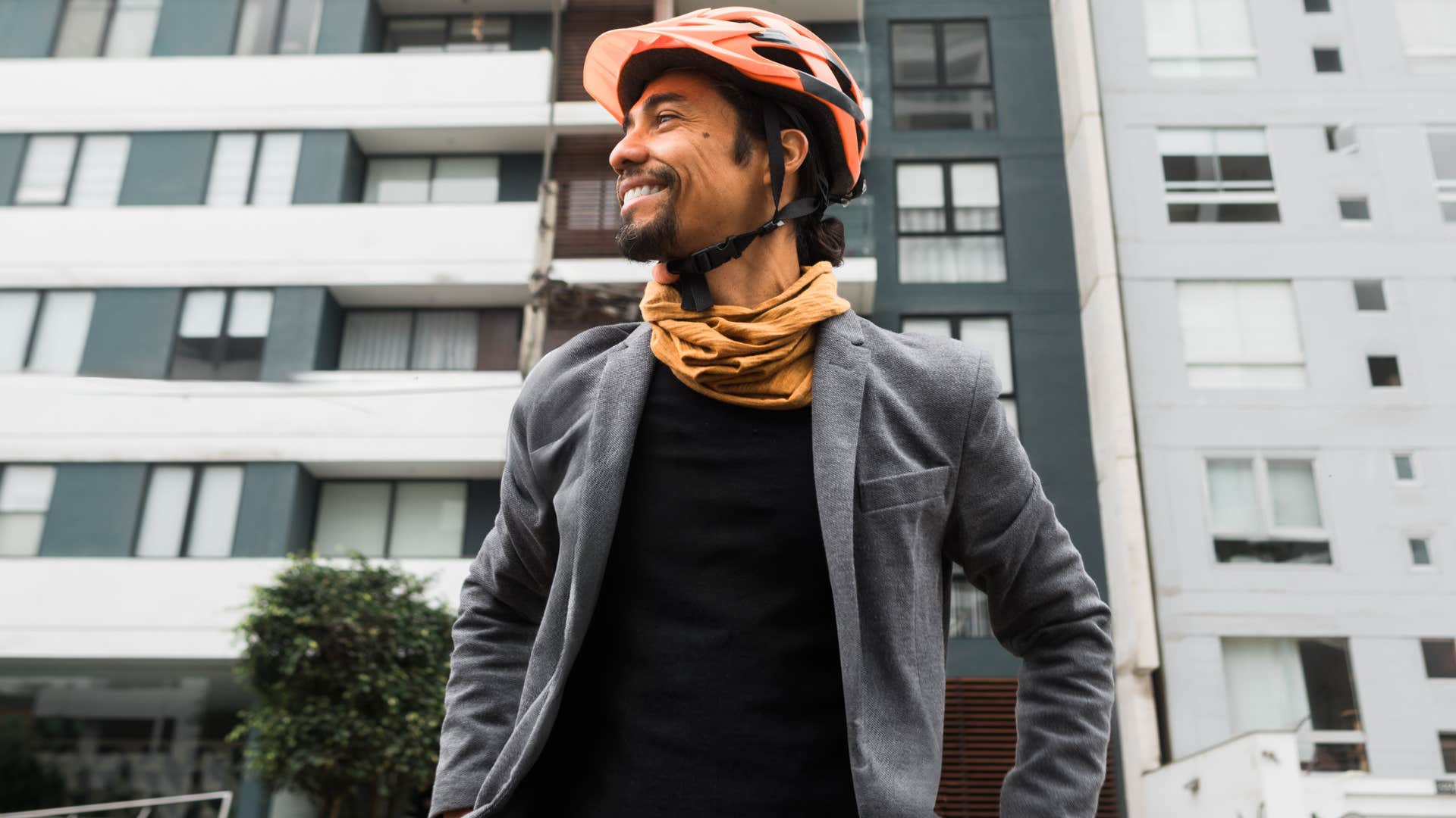 Spontaneous man smiling outside.