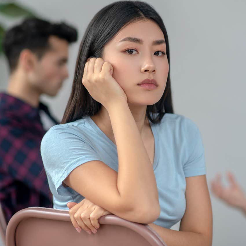 Introverted woman sitting in a group of people
