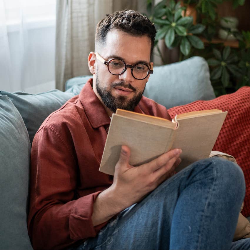 Man who's naturally quiet and curious reading a book at home