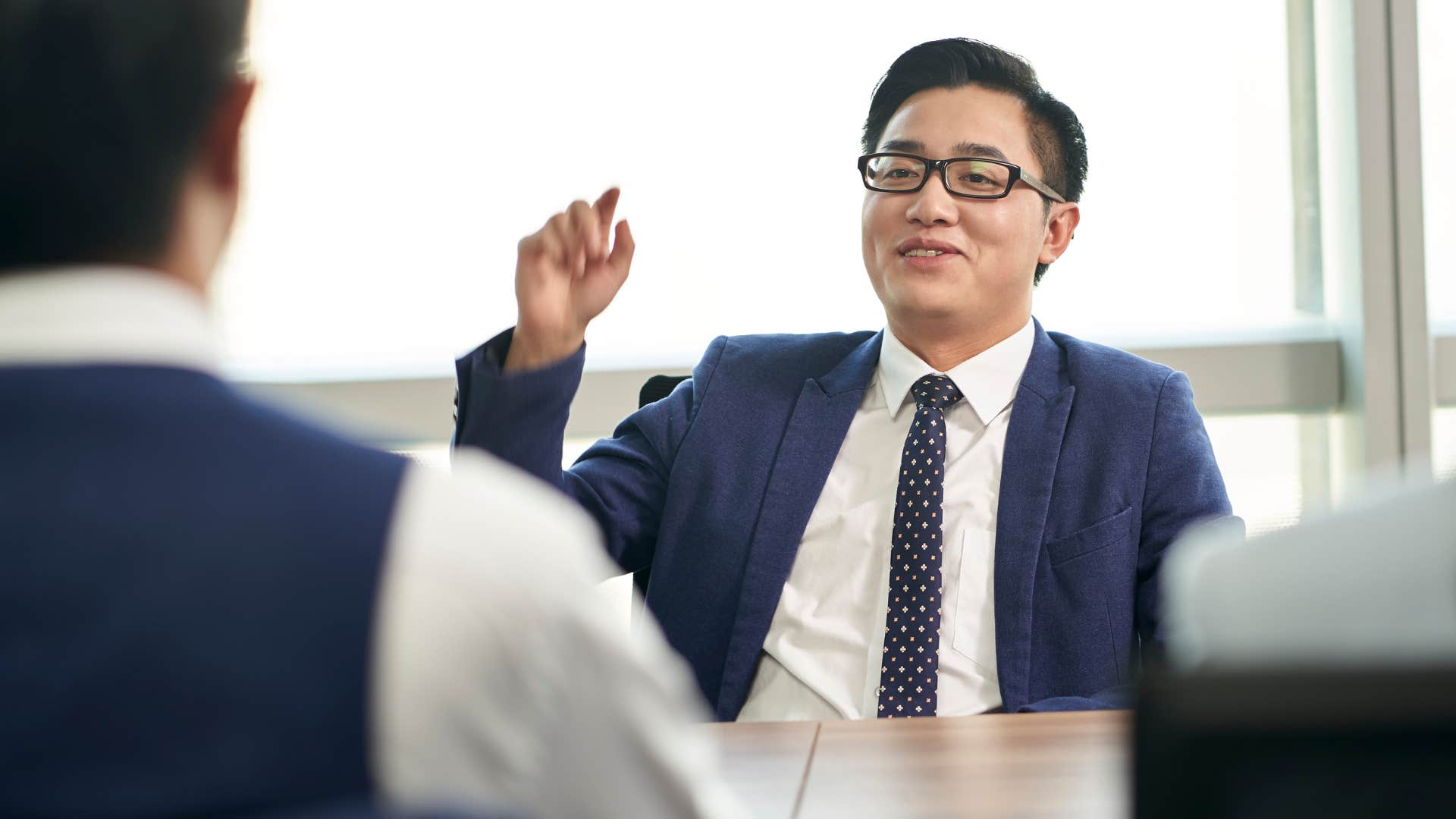 arrogant man bragging about goals and accomplishments at work