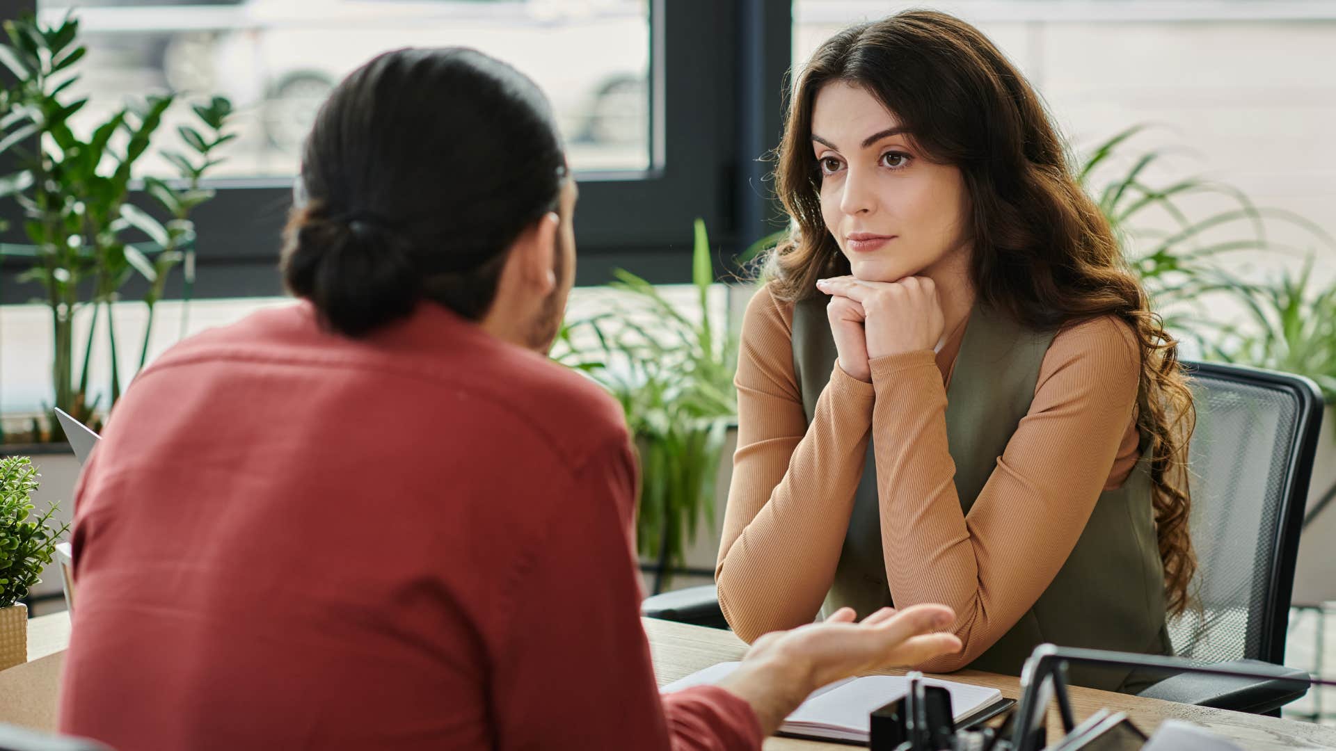 woman leaning into awkward silence in a work meeting