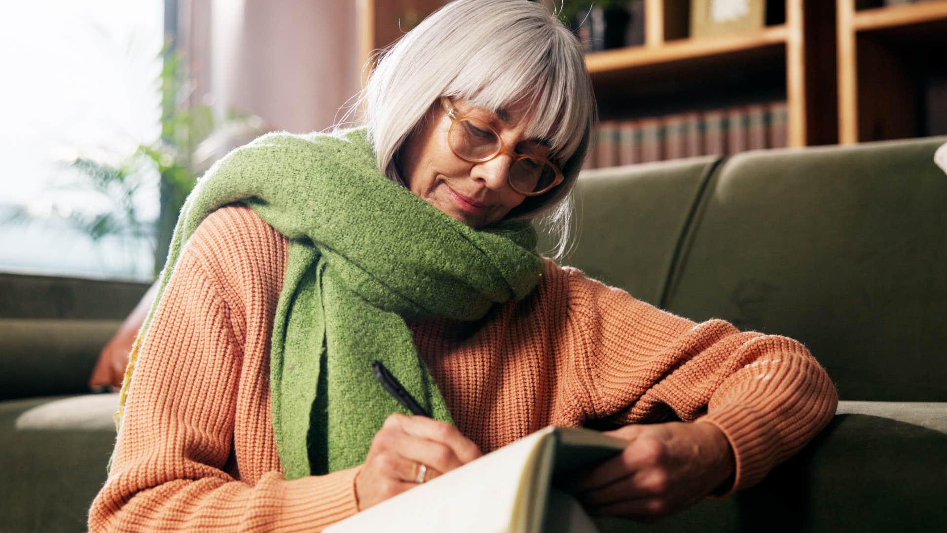 spiritually gifted woman feeling energized by idleness journaling