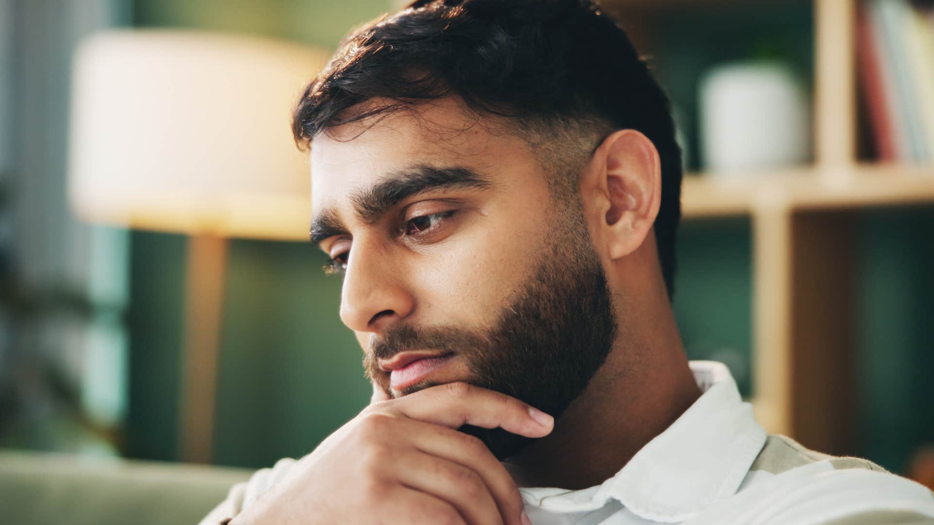 man acknowledging intense emotions sitting at home