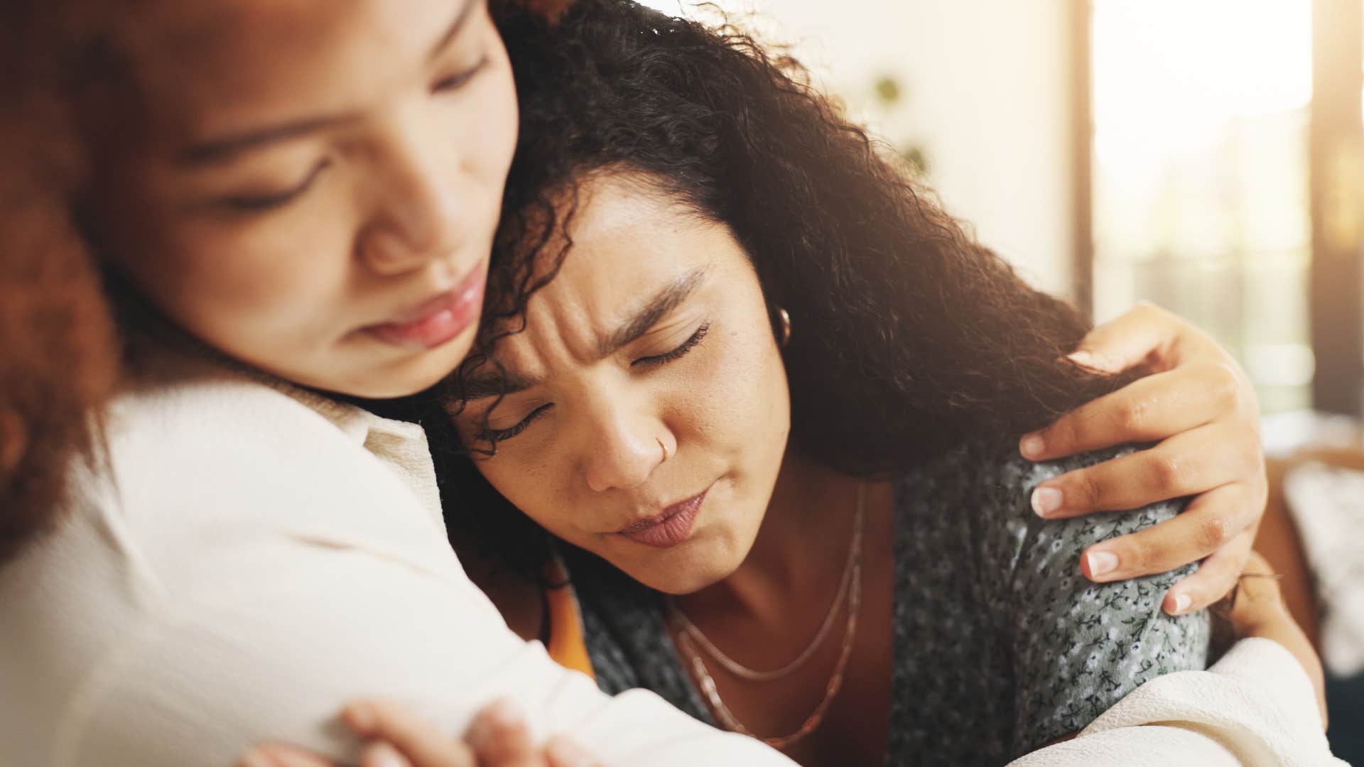 woman saying life is so unfair while hugging her friend