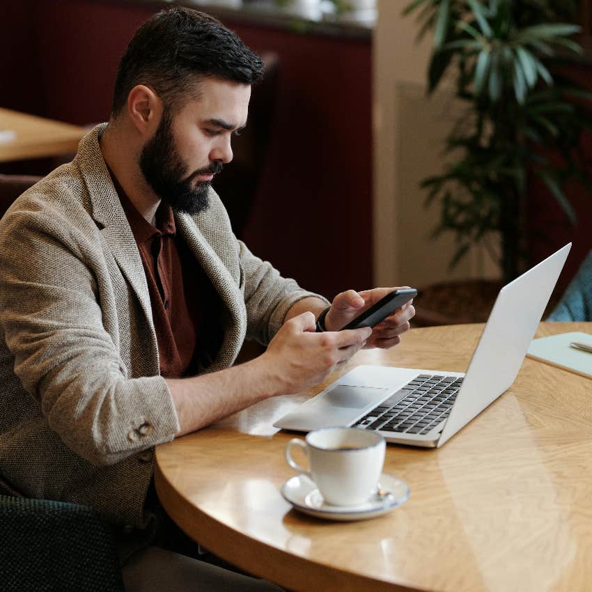 man with decreased productivity because he's using his phone during work