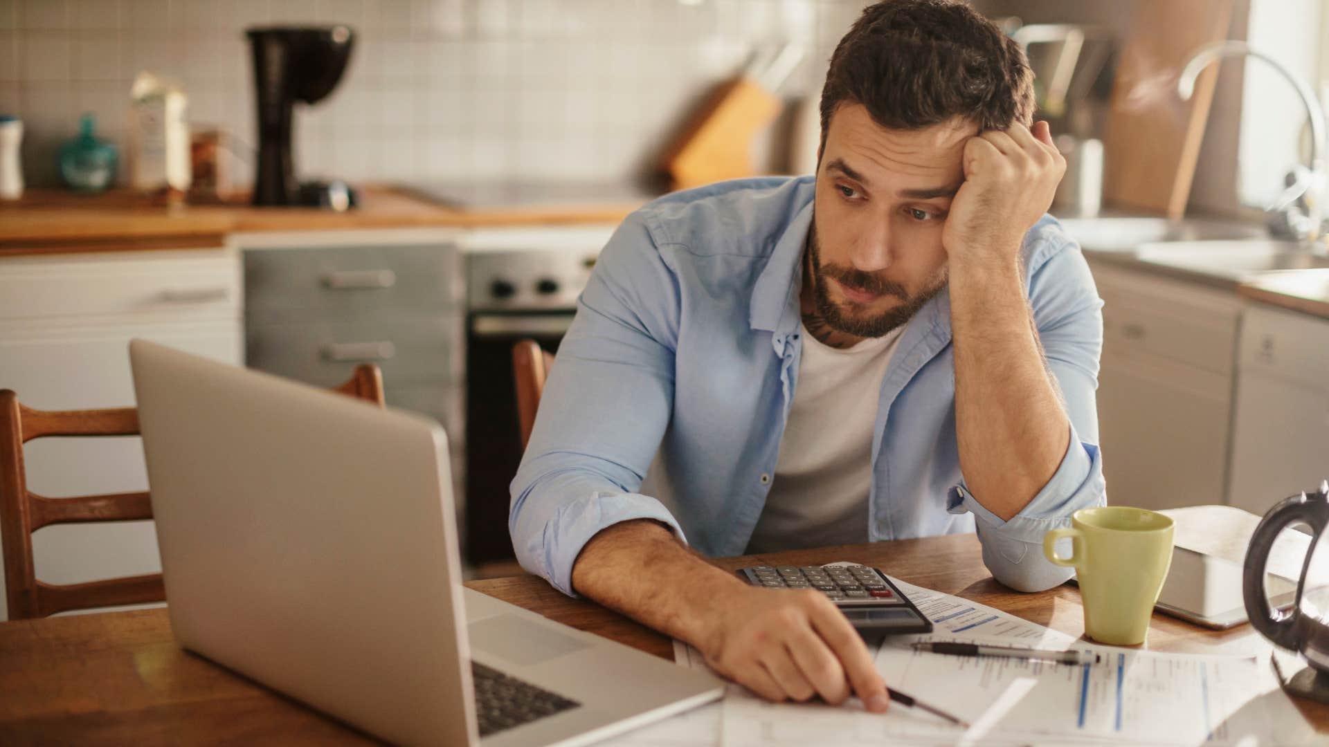 financially hopeful man going over his grocery budget