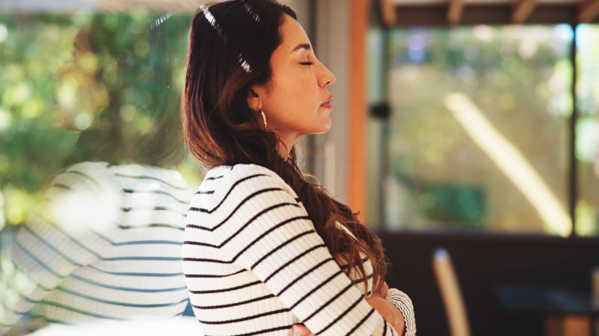 woman with energy awareness meditating at home