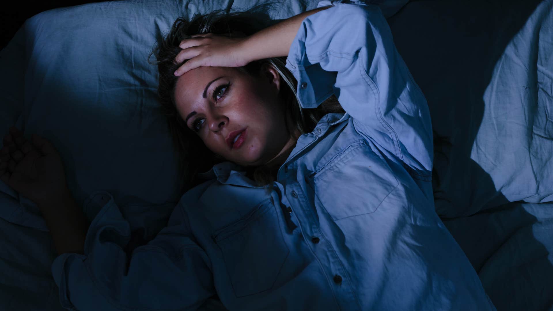 naturally vigilant woman lying awake in her bed