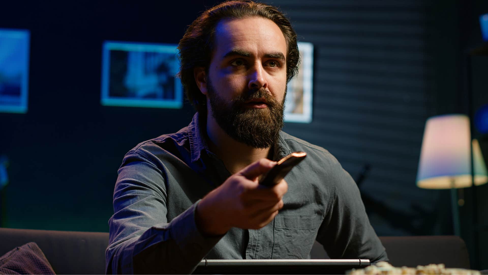 man who prefers to be in control watching TV late at night instead of sleeping