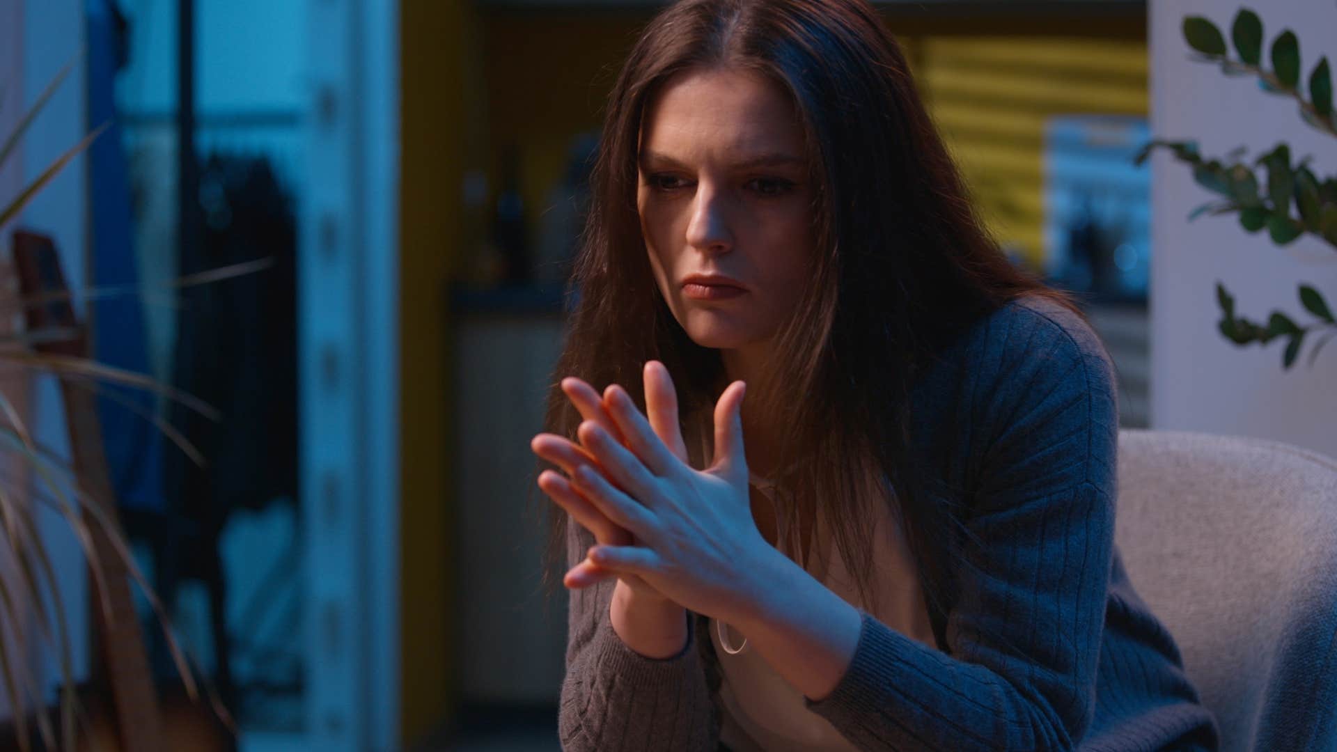 sensitive woman sitting awake at night in her house