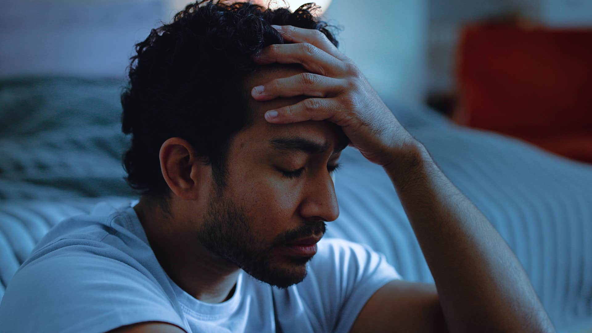 man obsessively worrying about his to-do list before bed