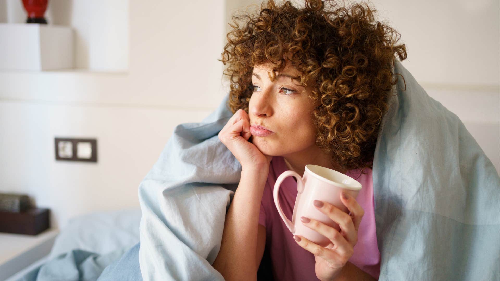 Woman who's always thinking about the future lying in her bed.