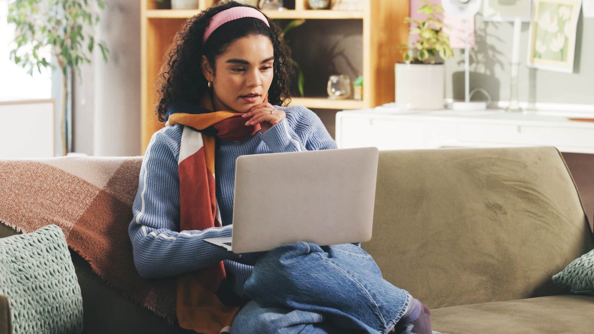 Creative woman lounging on a couch at home.