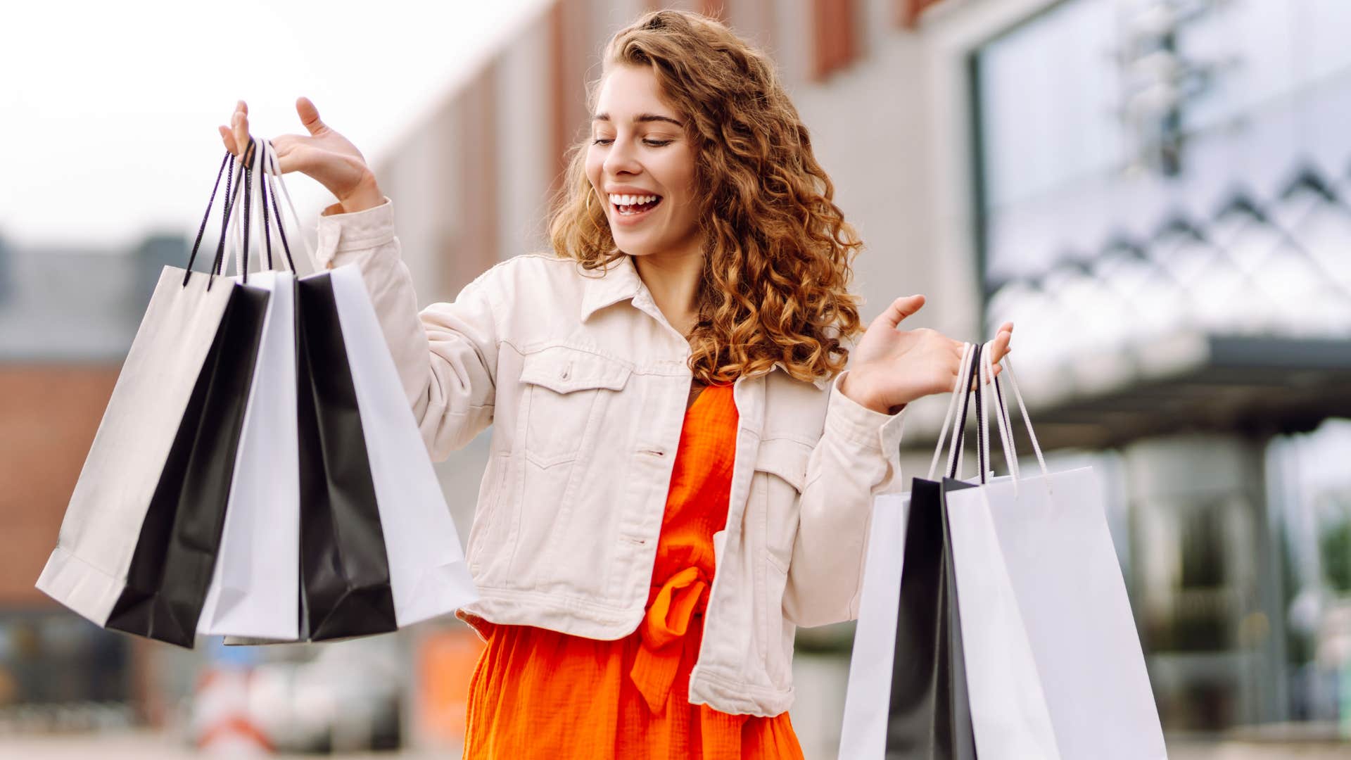 Happy person with many shopping bags showing lack of self awareness