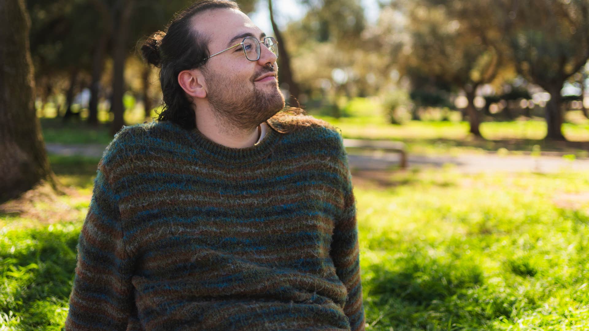 independent man sitting alone in a park