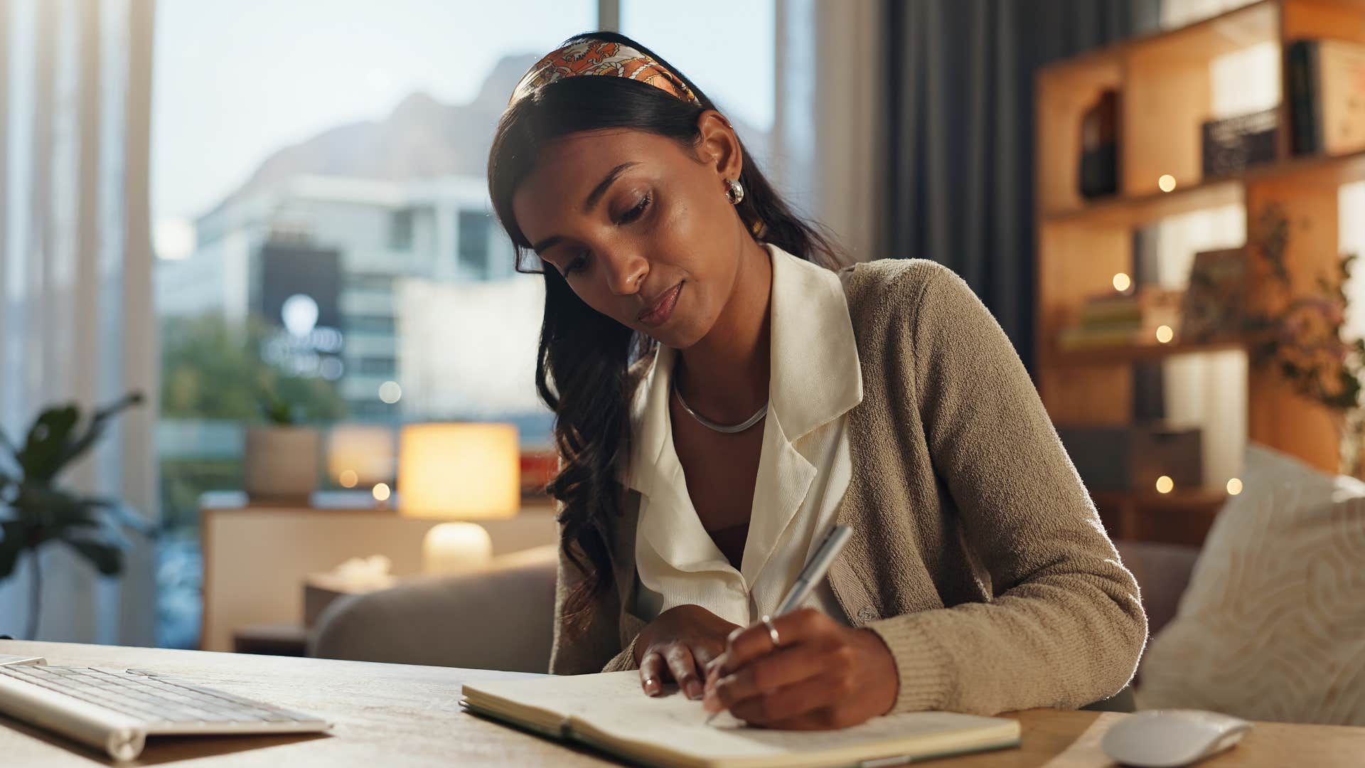 Focused person writes in notebook showing habit of planning after divorce