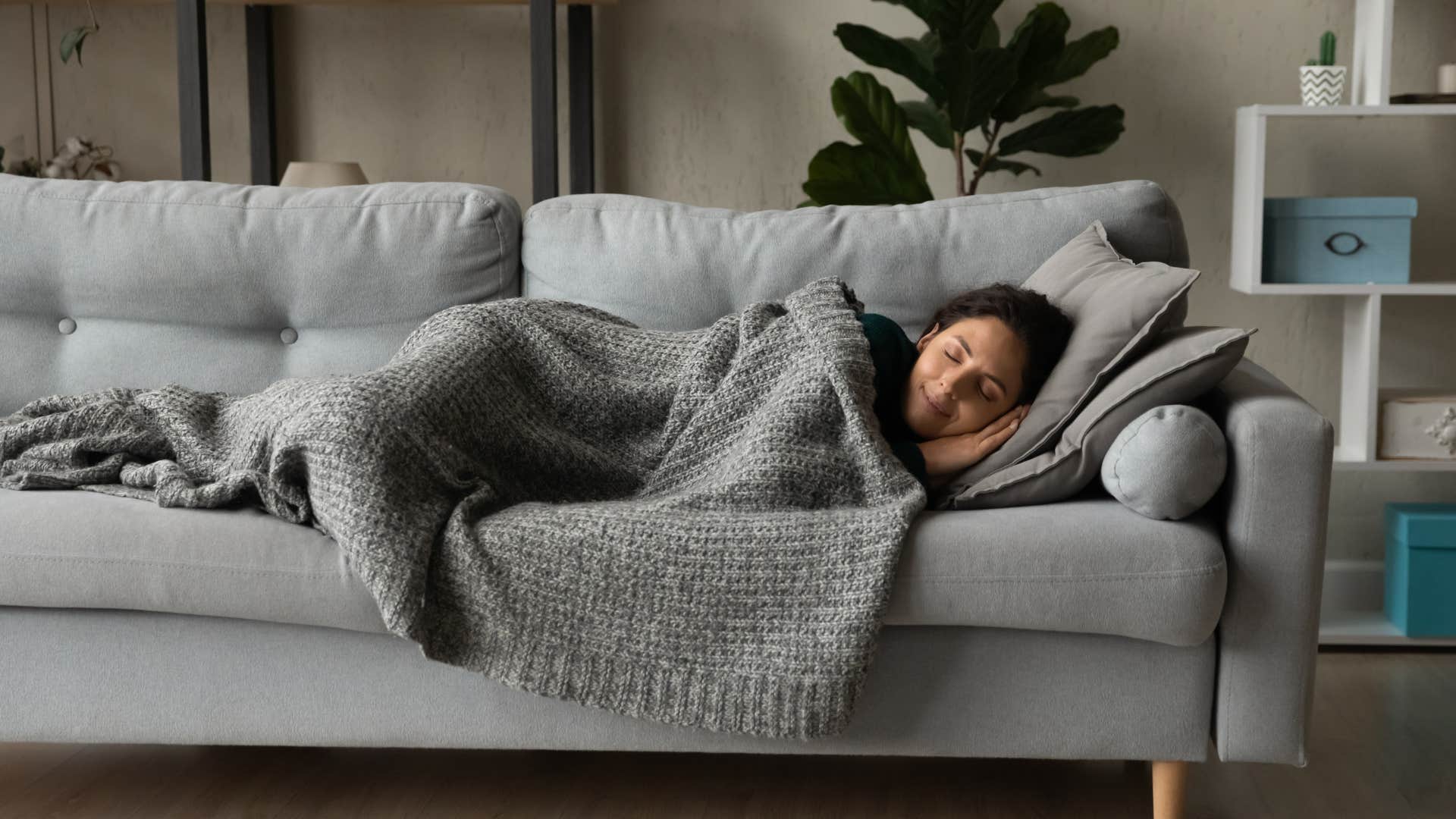 Peaceful person naps on couch showing importance of sleep after divorce