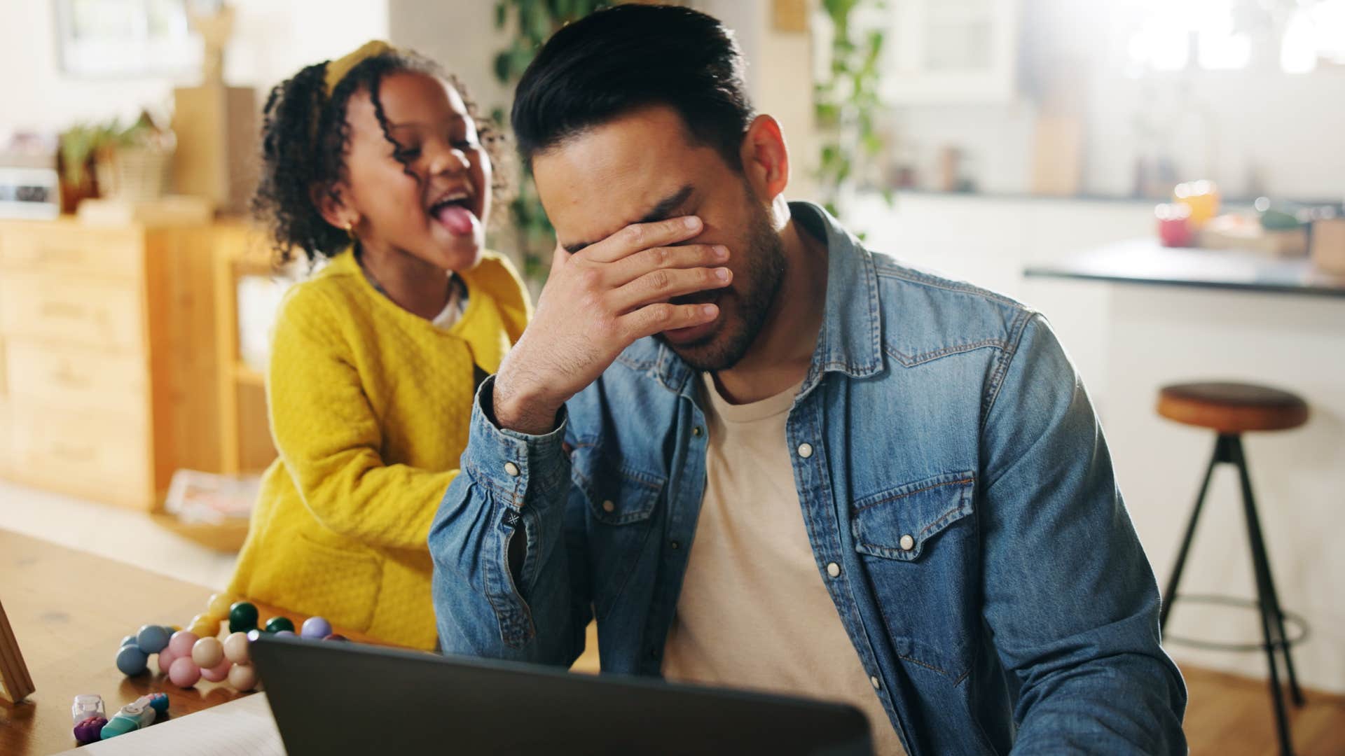 Man who's easily overstimulated sitting with his daughter.