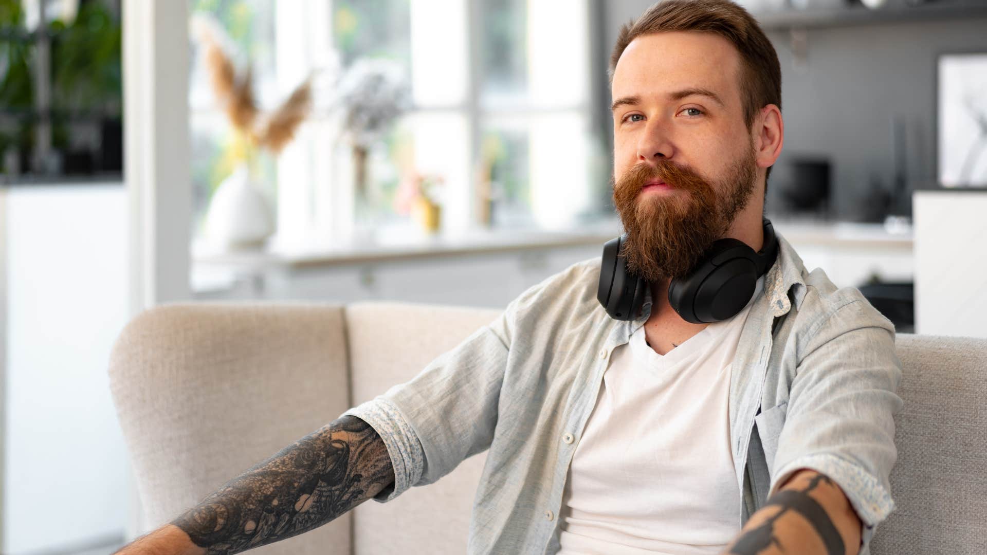 Introverted man sitting on his couch.